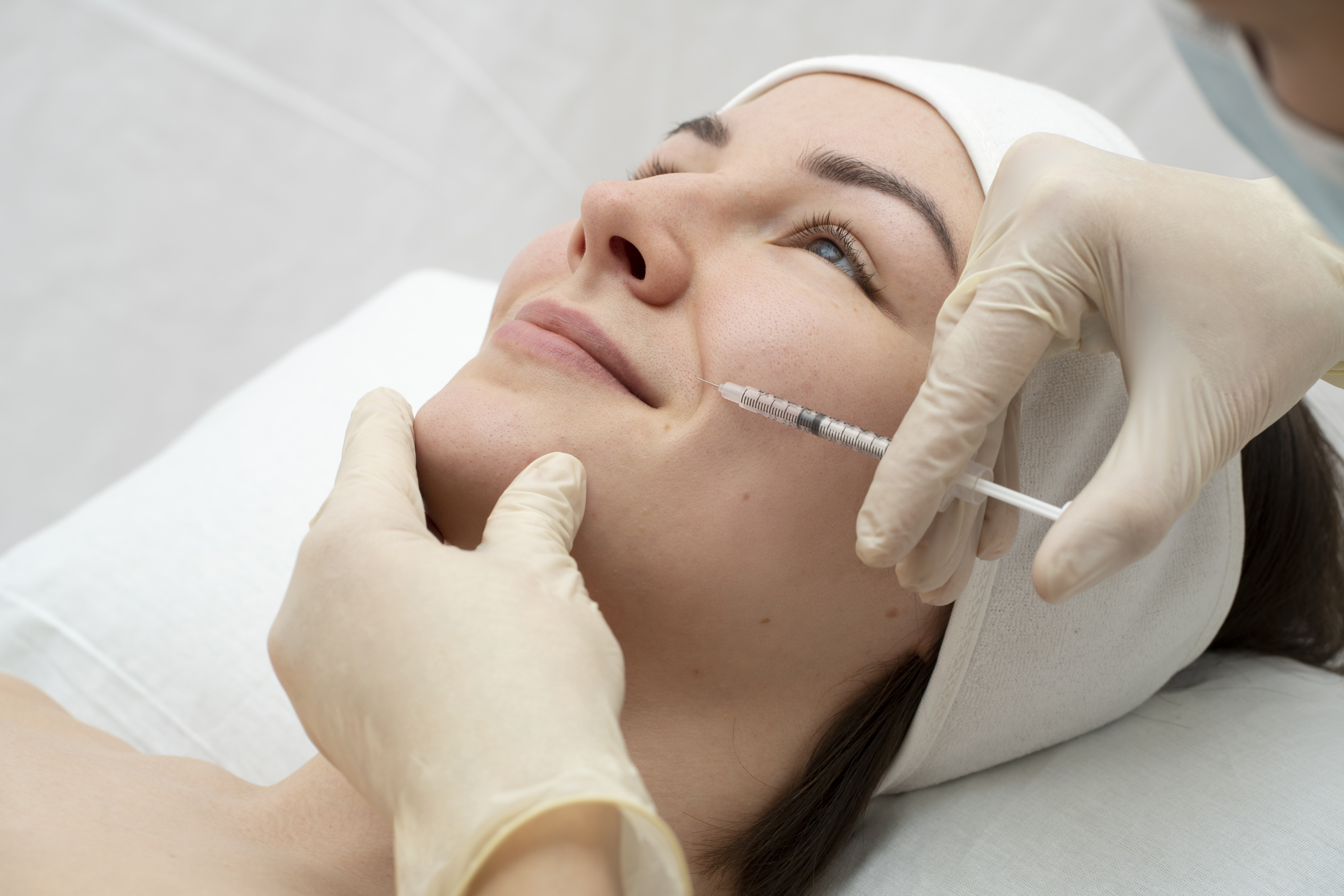 close up woman smiling during lip filler procedure